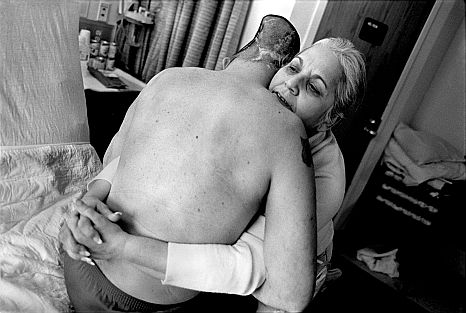 WEST ROXBURY, MASSACHUSETTS – MARCH 21: Nelida Bagley helps to lift her son, former Sgt. Jose Pequeno of the New Hampshire National Guard, from his bed at the West Roxbury VA Medical Center on March 21, 2008 in West Roxbury, Massachusetts. Thirty-four-year-old Pequeno, the chief of police of Sugar Hill, New Hampshire, lost forty percent of his brain after a grenade exploded in his Humvee while on patrol in Ramadi, Iraq on March 1, 2006.